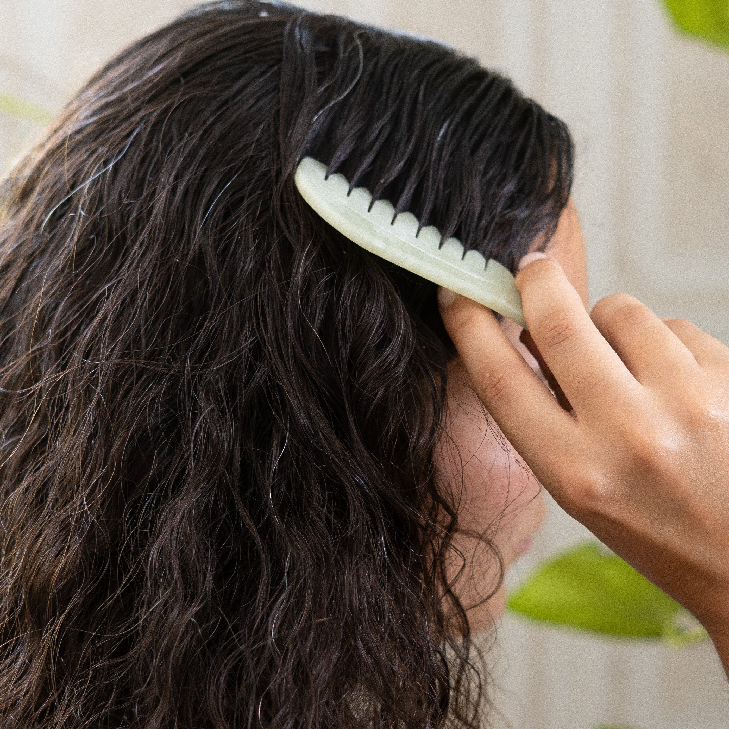 Jade scalp comb massaging the scalp