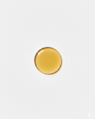 Gold circular oil  on a white backgroundrop