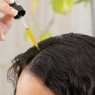 Guada oil dropper applied to the scalp