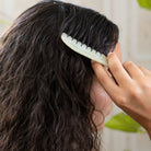 Jade scalp comb massaging the scalp
