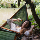 Resting in a hammock by the river with Nabuke in hand