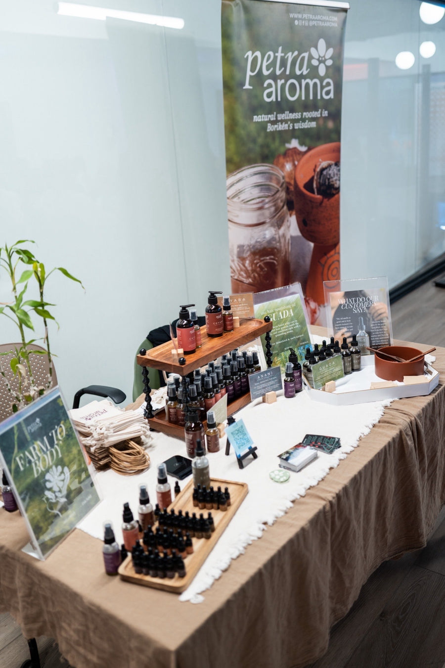 The full Petra Aroma line set up on a table at an in-person event